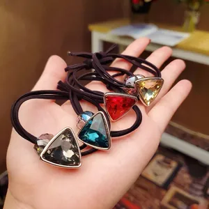 Set of four elastic hair bands featuring large geometric crystal gems and gold alloy edges