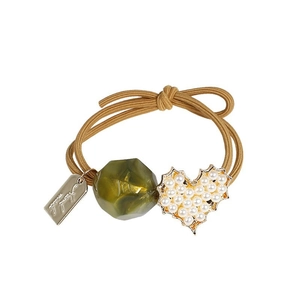 Elastic hair tie with olive green resin bead and heart pearl charm on white background