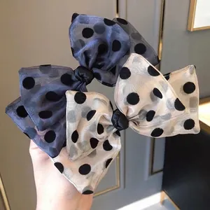Set of two large organza bow hair clips with chic black polka dots in blue and cream
