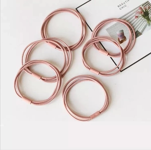 Detail of 6-piece pink elastic hair ties featuring a durable multi-strand braided design