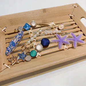 8-piece set of ocean-themed hair clips with starfish, pearls, and colorful resin geometric shapes