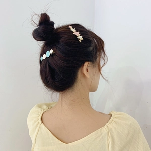 Korean style cream star and round hair clips worn on a neat bun for girls
