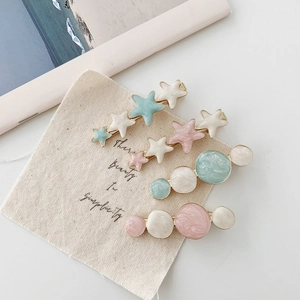 Set of 4 cream-colored star and marble pattern hair clips for women in macaron pastel tones