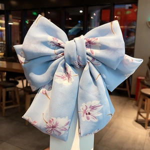 Elegant light blue chiffon hair clip with purple floral patterns and large bow design