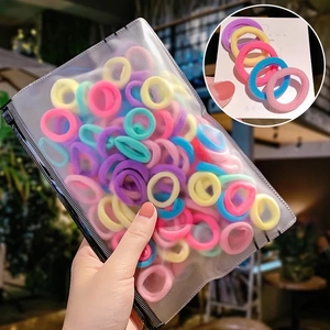 Detail of colorful elastic hair bands in a transparent PVC zipper storage pouch