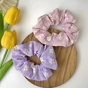 Floral scrunchie set with daisy pattern in soft pink and purple tones for women