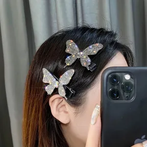 Dettaglio di fermagli per capelli a farfalla scintillanti con strass indossati sui capelli