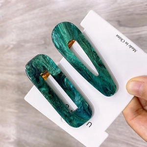 Elegant emerald green marble acetate hair clip set with sparkling gold glitter accents