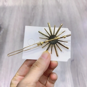 Sparkling snowflake hair clip with gold-plated sunburst design and back frog buckle