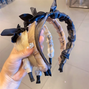 Three-piece set of mesh organza bow headbands in black, champagne gold, and brown colors