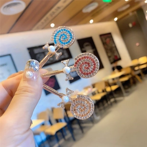 Vue détaillée de pinces à cheveux sucettes avec strass colorés et perles