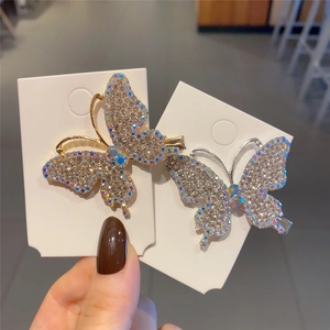 Close-up of butterfly hair clips with colorful rhinestones on a display card