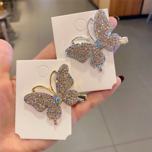 Sparkling butterfly hair clips with iridescent rhinestones in gold and silver finish