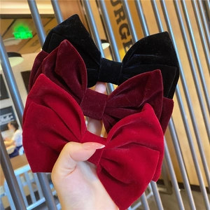 Three elegant velvet bow hair clips in black, burgundy and red colors for women