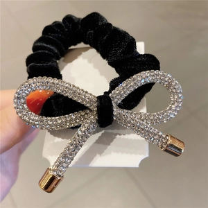 Elegant black velvet scrunchie with sparkling rhinestone bowknot and gold metal tips