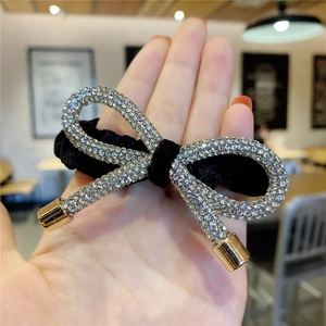 Elegant black velvet hair scrunchie with sparkling rhinestone bow and golden tips