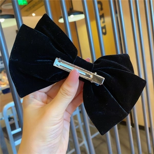 Detailed view of the black velvet bow hair clip with sturdy silver metal duckbill clamp