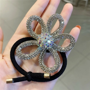 Close-up of sparkling rhinestone flower hair tie with high-elasticity black rope