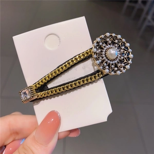 Baroque style gold chain hair clip with large pearl and sparkling crystals on card