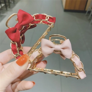 Elegant gold metal ribbon bow hair claw clips in vintage red and soft pink silk