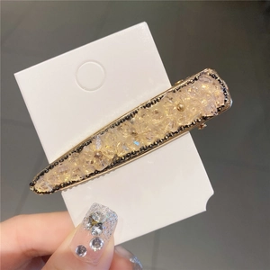 Détail de la pince à cheveux à fleurs en cristal avec bordure perlée et base dorée