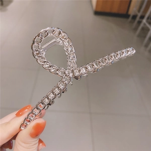Vue détaillée de la pince à cheveux en métal argenté avec design de chaîne et ressort