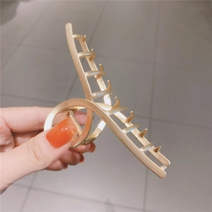 Cross hollow matte gold metal hair claw clip with minimalist geometric design for women