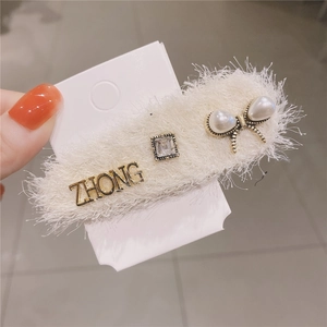 Elegant plush hair clip with ZHONG metal lettering and faux pearl butterfly bow detail