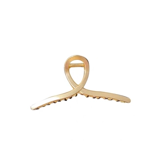 Matte gold hollow cross claw clip with metal teeth for women hairstyle in white background