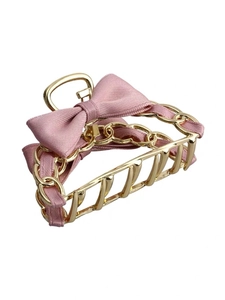 Elegant gold metal hair claw clip featuring a pink ribbon bow with fine twill texture