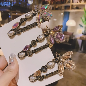 Baroque vintage bee hair clips with pearls and crystals on decorative display card