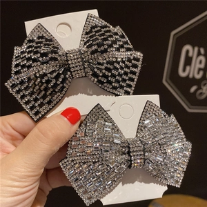 Detail of sparkling rhinestone bow hair clips with silver and black crystals on metal base
