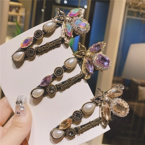 Vintage bee hair clips set with pearls and crystals in bronze finish on display card
