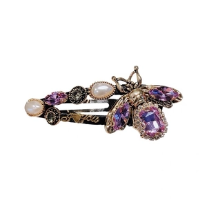 Baroque bee hair clip with purple crystals, pearls, and 'I heart you' lettering detail