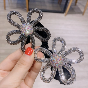 Detail of sparkling crystal flower hair ties with rhinestones and black velvet band