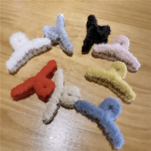 Close-up showing a variety of colorful plush hair claws with soft faux fur texture