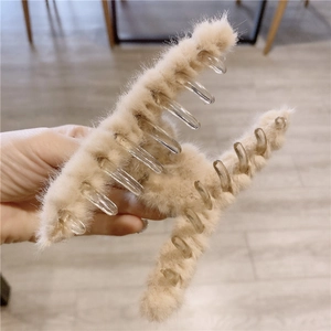 Detail showing the plush faux rabbit fur texture and sturdy grip of the large beige hair claw