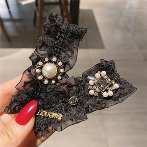 Elegant black lace hair clip with pearls, rhinestones and Loveme metal charm detail