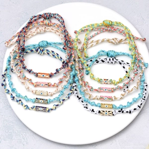 Set of 10 woven evil eye bracelets with hexagonal gold beads in vibrant colors