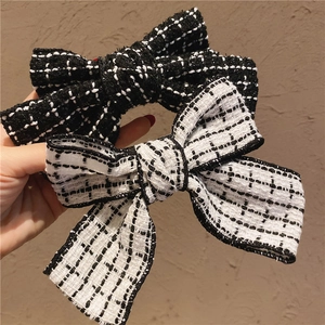 Elegant tweed bow hair clips in black and white pattern for retro women's hairstyle
