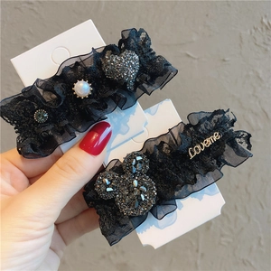 Macro shot of black lace hair clips featuring faux pearl and Mickey shape rhinestones