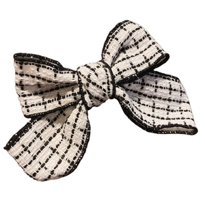 Elegant tweed bow hair clip in black and white vintage style for women's hairstyles