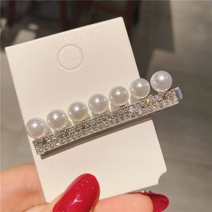 Gros plan détaillé d'une pince à cheveux de luxe avec perles blanches et cristaux étincelants