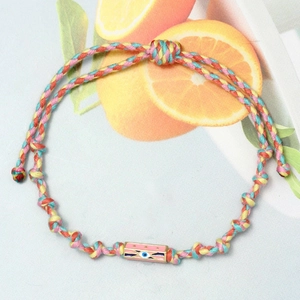 Macro shot of colorful braided cord evil eye bracelet with adjustable golden slider