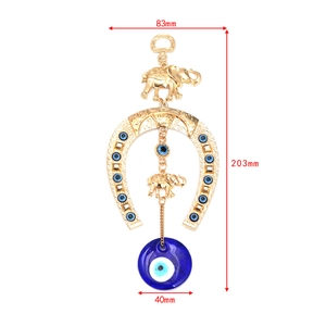 Detail view of Evil Eye wall hanging with gold horseshoe and elephant, sizing 203mm by 83mm