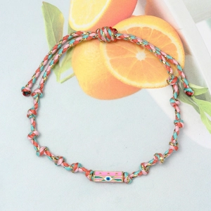 Detail view of colorful braided Evil Eye bracelet with adjustable cord and enamel charm