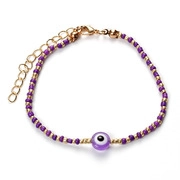 Detail of purple Evil Eye beaded bracelet with gold lobster clasp and extension chain