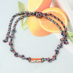 Detailed shot of handmade woven rope bracelet with evil eye charm and hexagonal beads