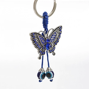 Detail of blue butterfly keychain with evil eye beads and sparkling rhinestones