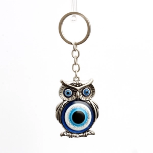 Detail of owl evil eye keychain featuring silver alloy and blue nazar glass beads